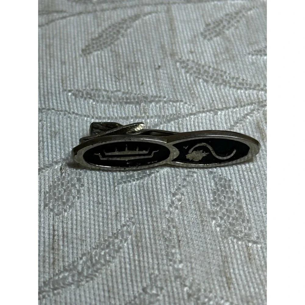 Vintage Anson tie clip featuring a crown and sine wave